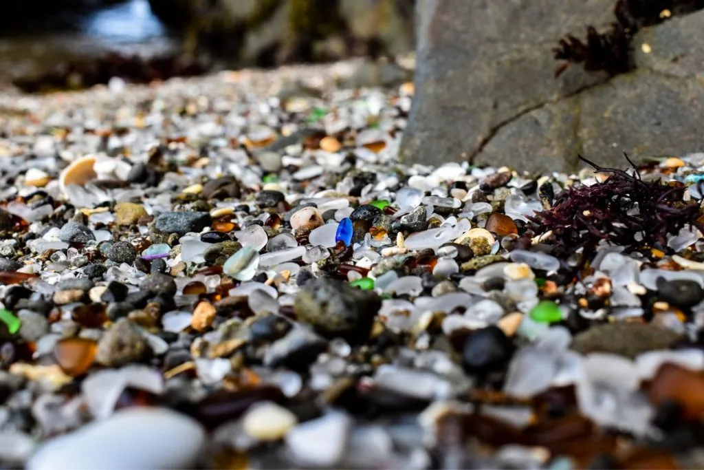 A beach completely filled with stones, pebbles, and brightly colored beach glass.
